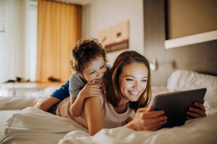 woman-son-tablet-hotel-room-technology-guest-amenities-iStock-597666184
